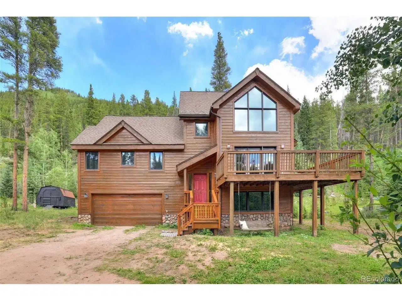 Image 1: Exterior of home, backing up to National Forest