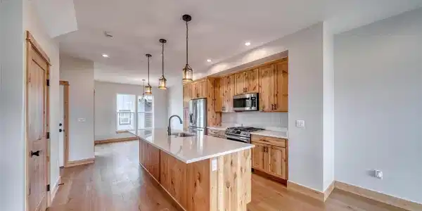Image 2: Open kitchen with large island and solid wood cabinets