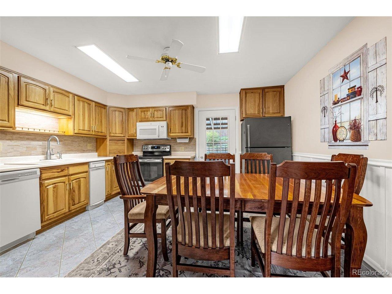 Image 2: Heart of the home the walk-out kitchen; tile flooring, wall of hickory cabinets, smooth counters, several lazy susans, appliance garage, pantry and ample room for larger table. Image 2: Heart of the home the walk-out kitchen; tile flooring, wall of hickory cabinets, smooth counters, several lazy susans, appliance garage, pantry and ample room for larger table.