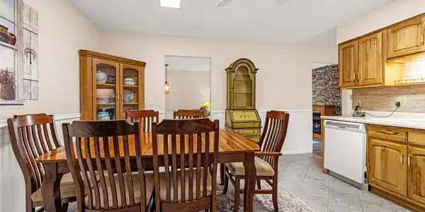 Image 3: Bright and roomy with wainscoting details makes this kitchen perfect for get togethers. Smooth cooktop conventional range with ample workspace and storage with access to the covered deck makes hosting even easier. Image 3: Bright and roomy with wainscoting details makes this kitchen perfect for get togethers. Smooth cooktop conventional range with ample workspace and storage with access to the covered deck makes hosting even easier.