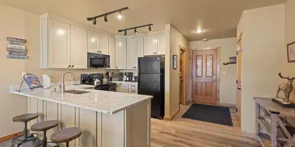 Image 2: Modern kitchen featuring a breakfast bar with comfortable stool seating, perfect for casual dining and entertaining. Image 2: Modern kitchen featuring a breakfast bar with comfortable stool seating, perfect for casual dining and entertaining.