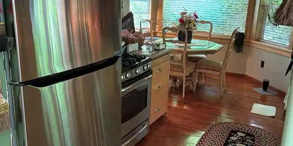 Image 4: roomy gally kitchen opening up to cozy dining   room
