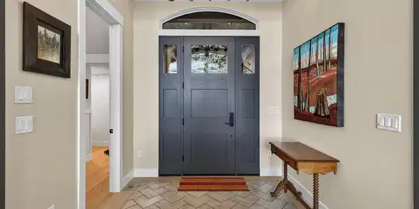 Image 4: Front Hall, With Herringbone tile and an arched window, it is a welcoming entrance to the is beautiful home.