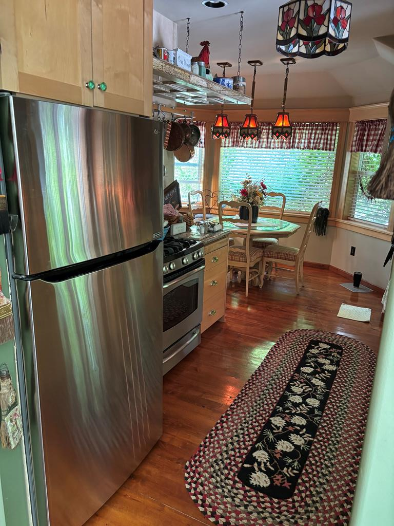 Image 4: roomy gally kitchen opening up to cozy dining   room