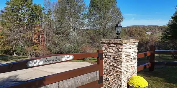Image 3: Welcome to Daisy Log, Gated entrance with Stone Pillars, Custom Log Home with Mountain Views, Lakefront & Guest House