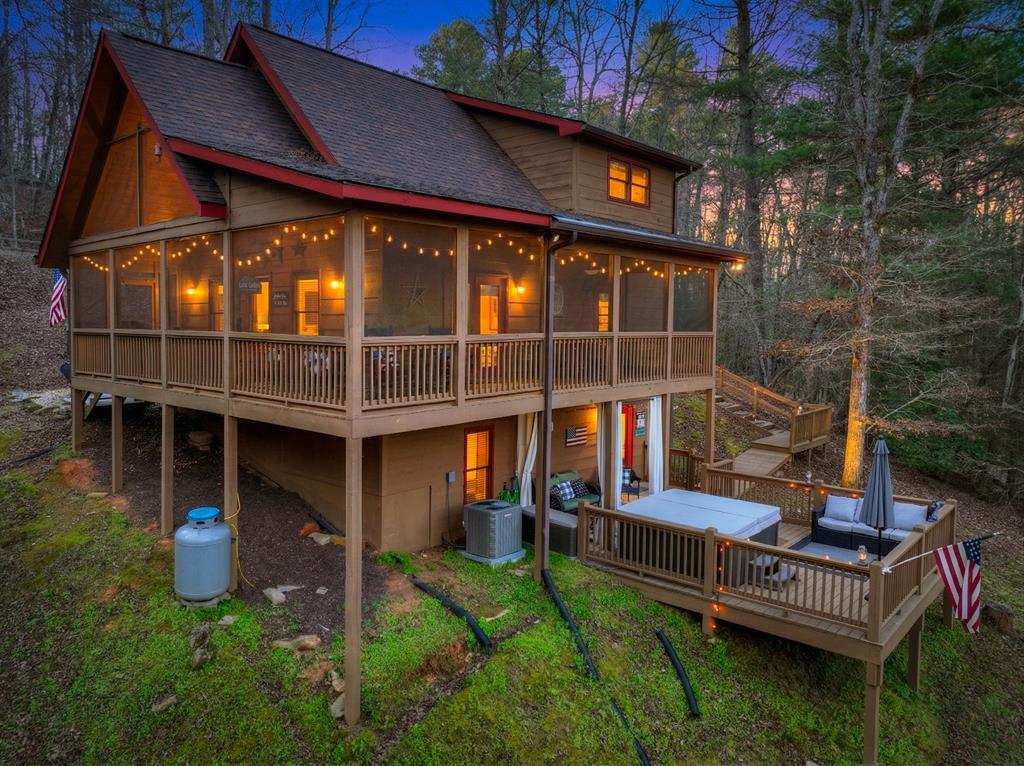 Image 2: Back of home with upper screen in porch and terrac