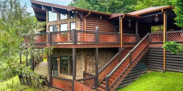 Image 2: The wall of windows to take in all that nature has to offer.  Hunter Douglass Insulated remote controlled blinds installed in each window!