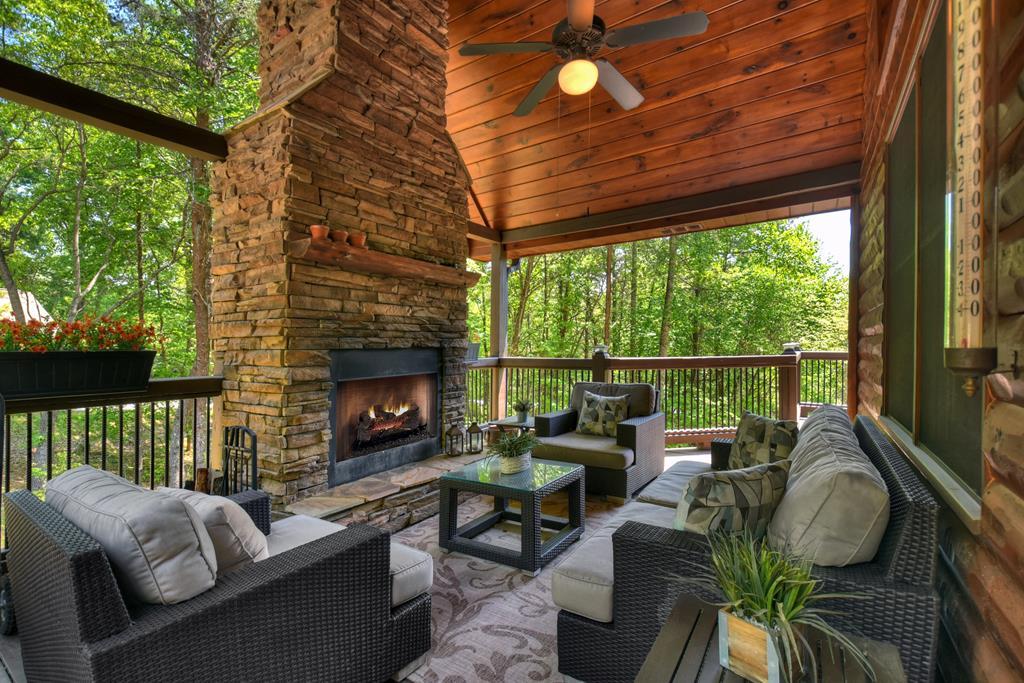 Image 3: Covered porch with fireplace, Real wood burning rock fireplace on main level deck