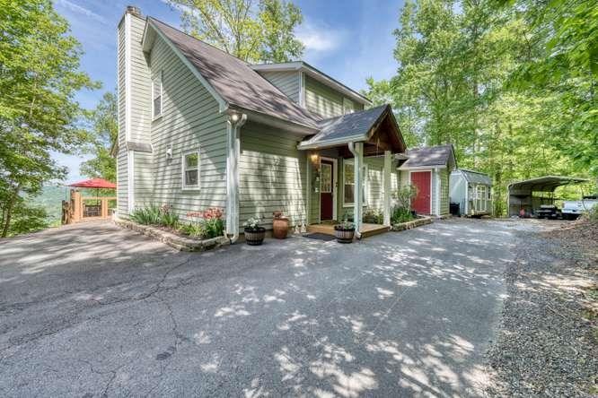 Image 3: Driveway side showing Shop & Carport