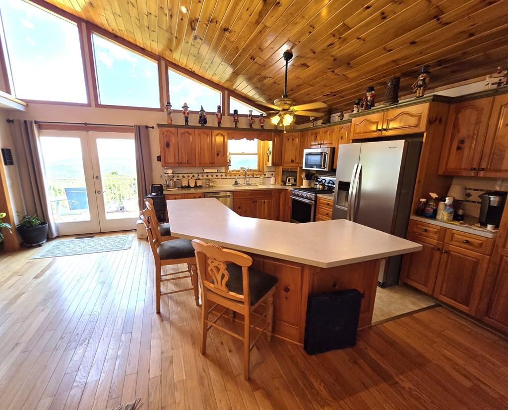 Image 3: LARGE ISLAND KITCHEN, FRENCH DOORS OPEN TO DECK