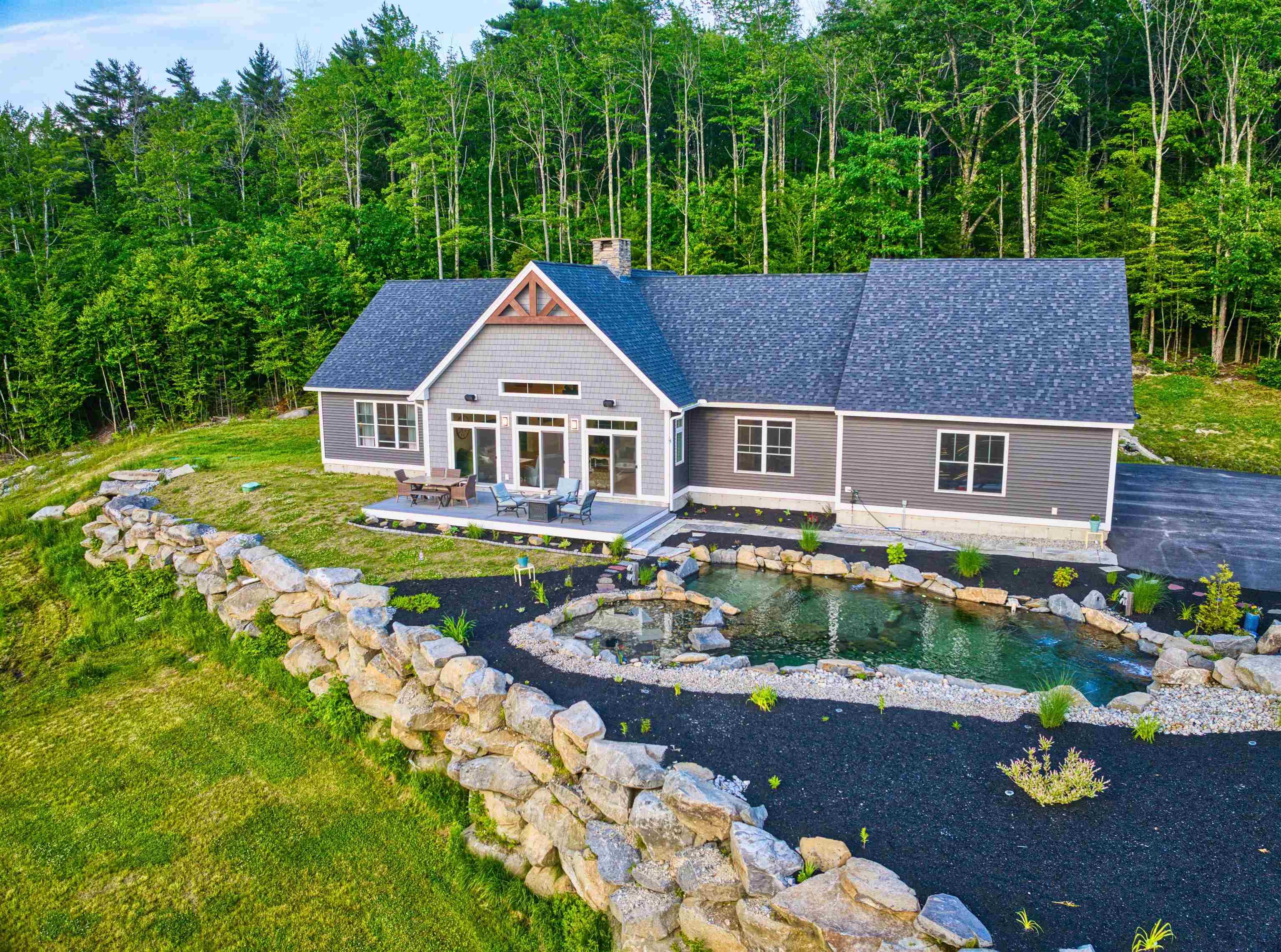 Image 1: Front of home with pond