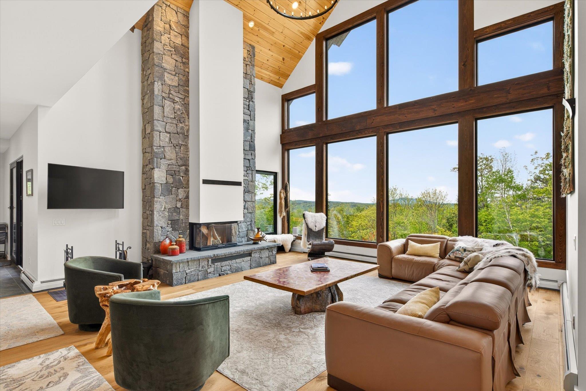 Image 4: Floor to Ceiling Fireplace, Wall of Windows, Wood Flooring