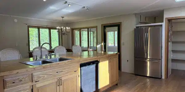 Image 4: Large kitchen island with sunshine from skylights showing!