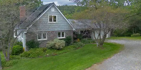 Image 2: STONE AND CEDAR SIDING