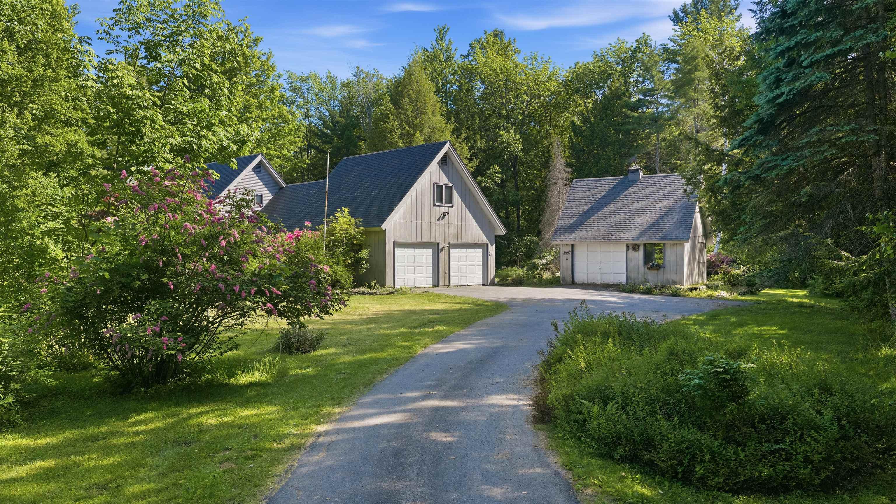 Image 4: Approach to home through paved driveway surrounded by mature Image 4: Approach to home through paved driveway surrounded by mature