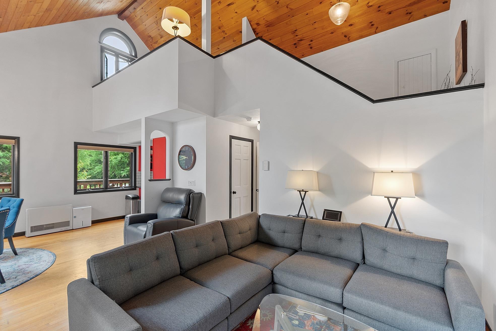 Image 3: Hardwood floors, gas fireplace, ceiling fan, sliding door out to the wrap around deck, Main living area
