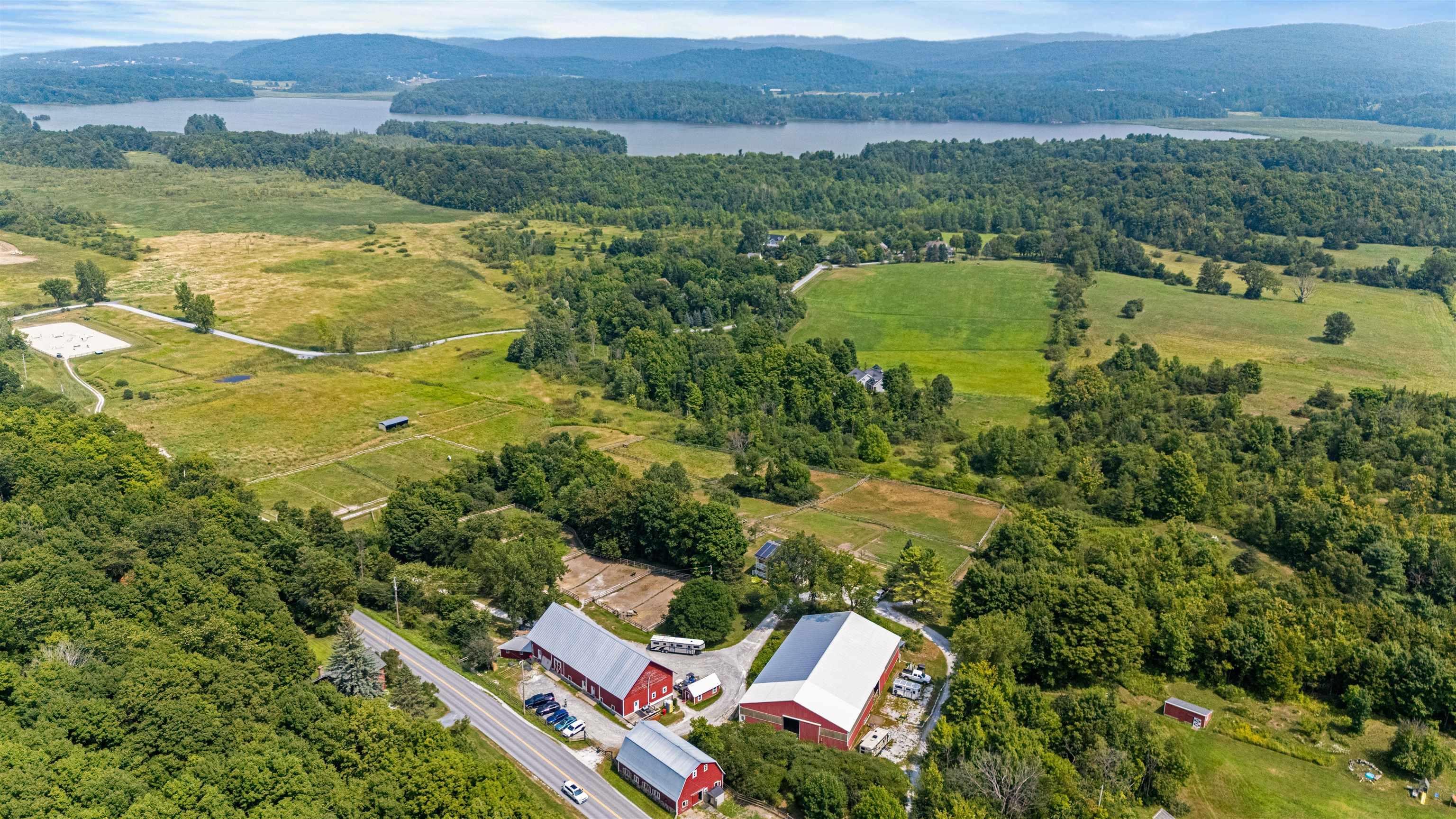 Image 1: close up of the new barn roofs and Shelburne Pond in the distance Image 1: close up of the new barn roofs and Shelburne Pond in the distance