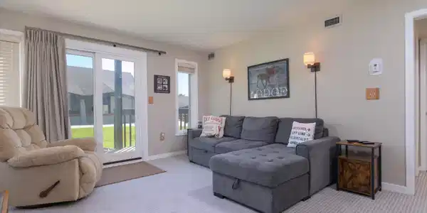 Image 2: Living room with updated slider leading out to deck