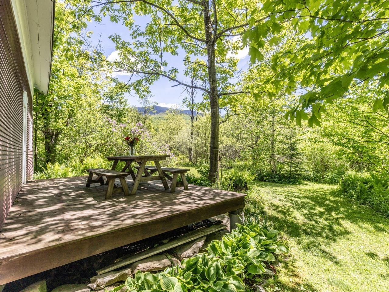 Image 3: Back deck with forest views Image 3: Back deck with forest views