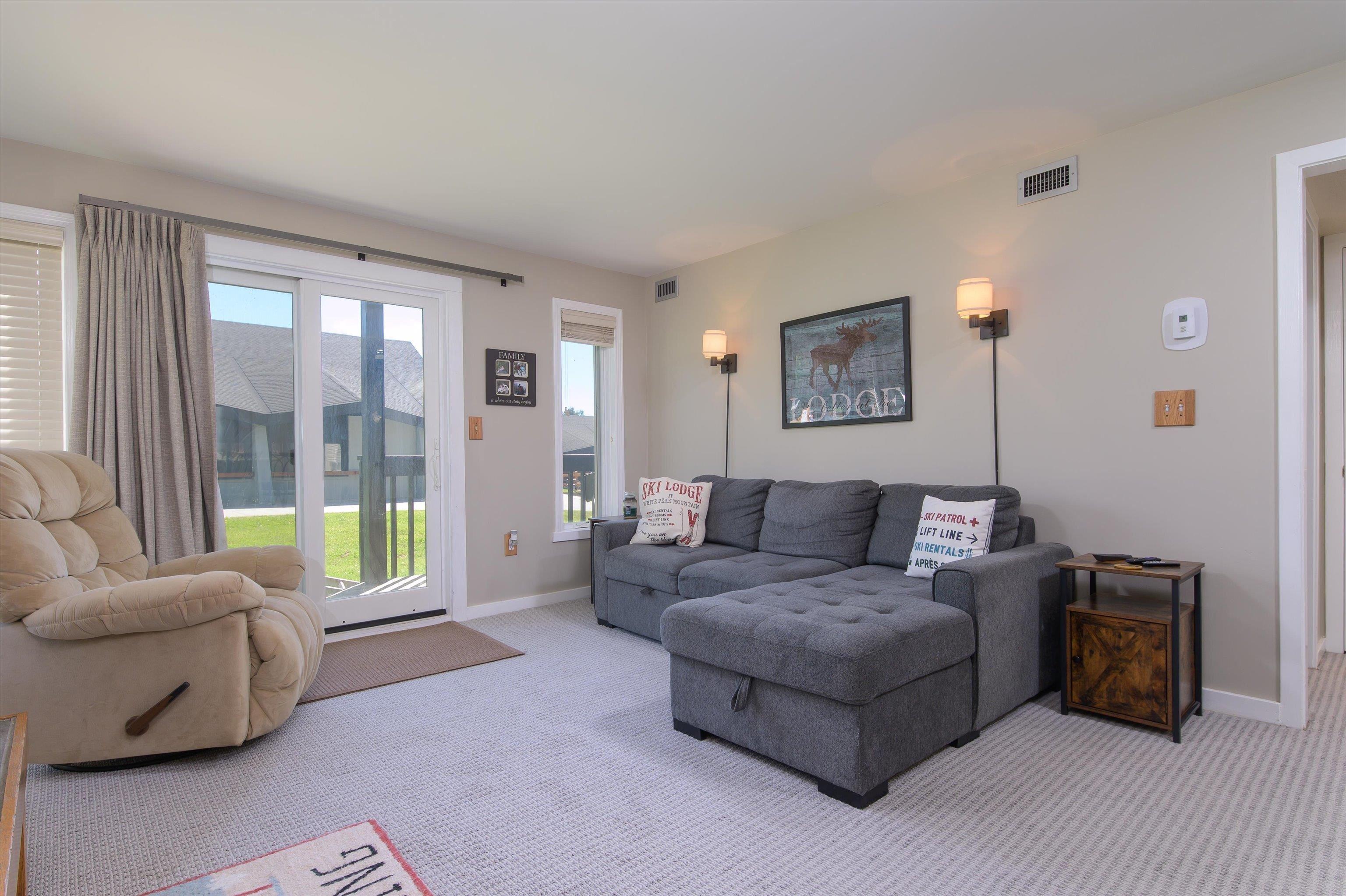 Image 2: Living room with updated slider leading out to deck Image 2: Living room with updated slider leading out to deck