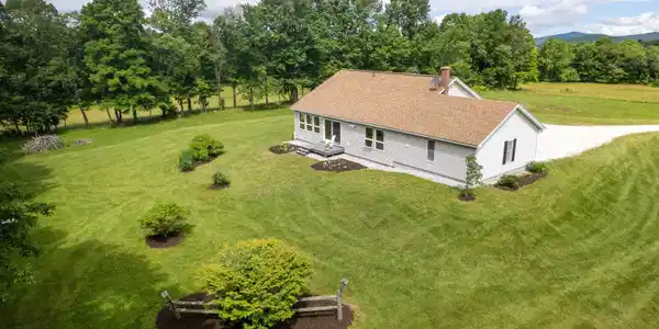 Image 2: The House is Surrounded by a Beautiful Yard