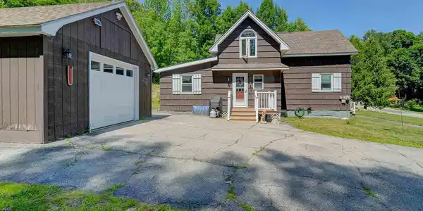 Image 2: 1-car detached garage with storage above.