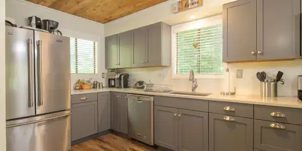 Image 2: Updated kitchen highlighted by wood ceiling