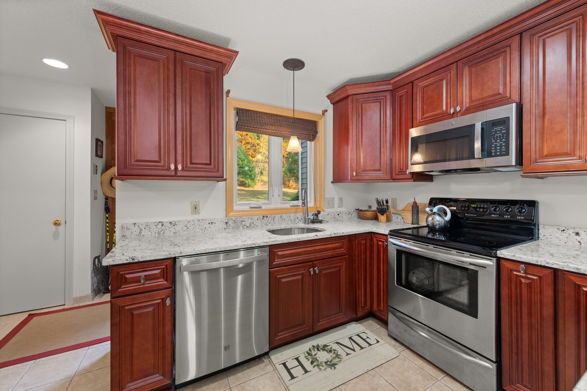 Image 2: Cherry cabinets and stainless appliances