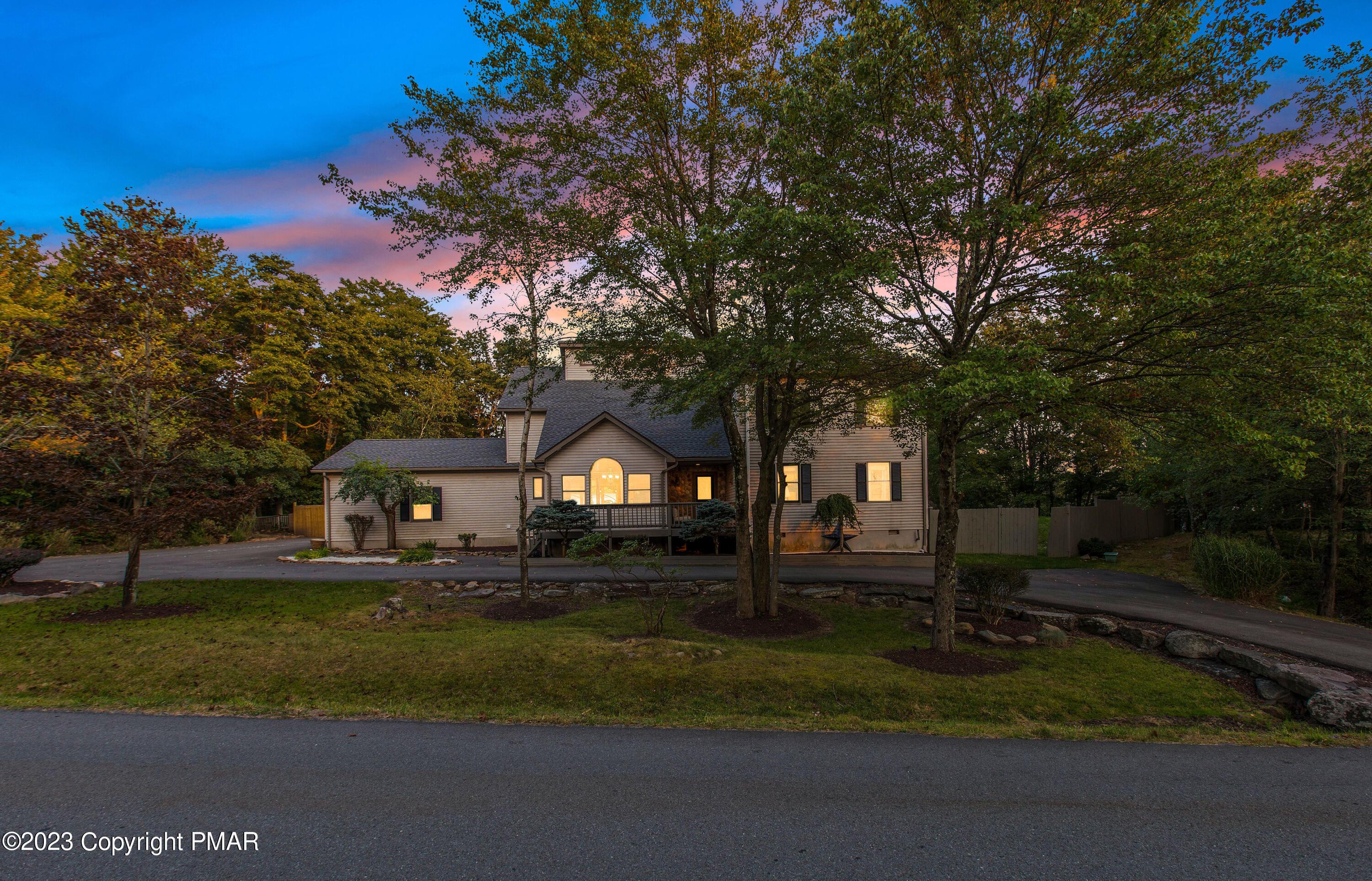 Image 2: Front Dusk View w/ Circular Driveway