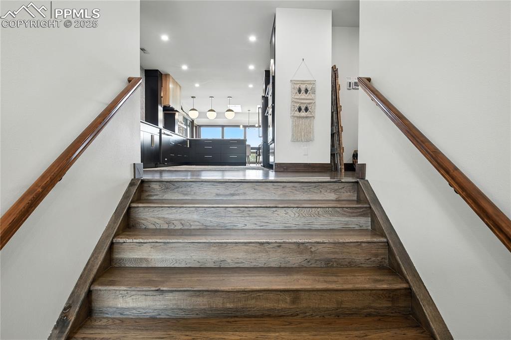 Image 4: Stairs with hardwood / wood-style floors and recessed lighting