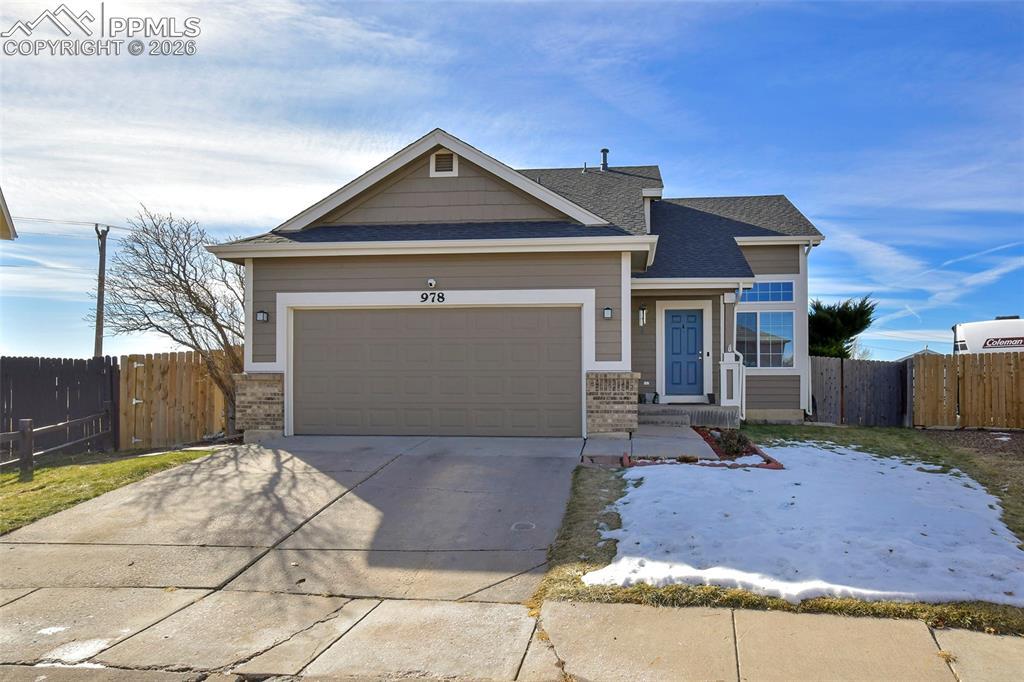 Image 1: View of front of property featuring driveway, an attached garage, and a shingled roof