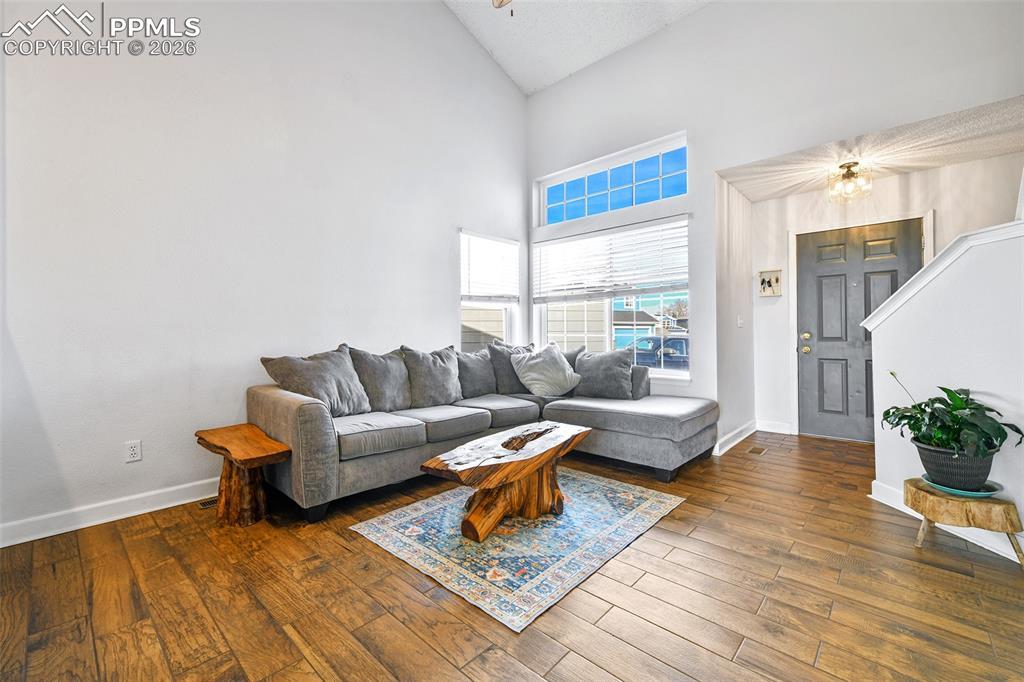Image 2: Living room featuring high vaulted ceiling and hardwood / wood-style flooring