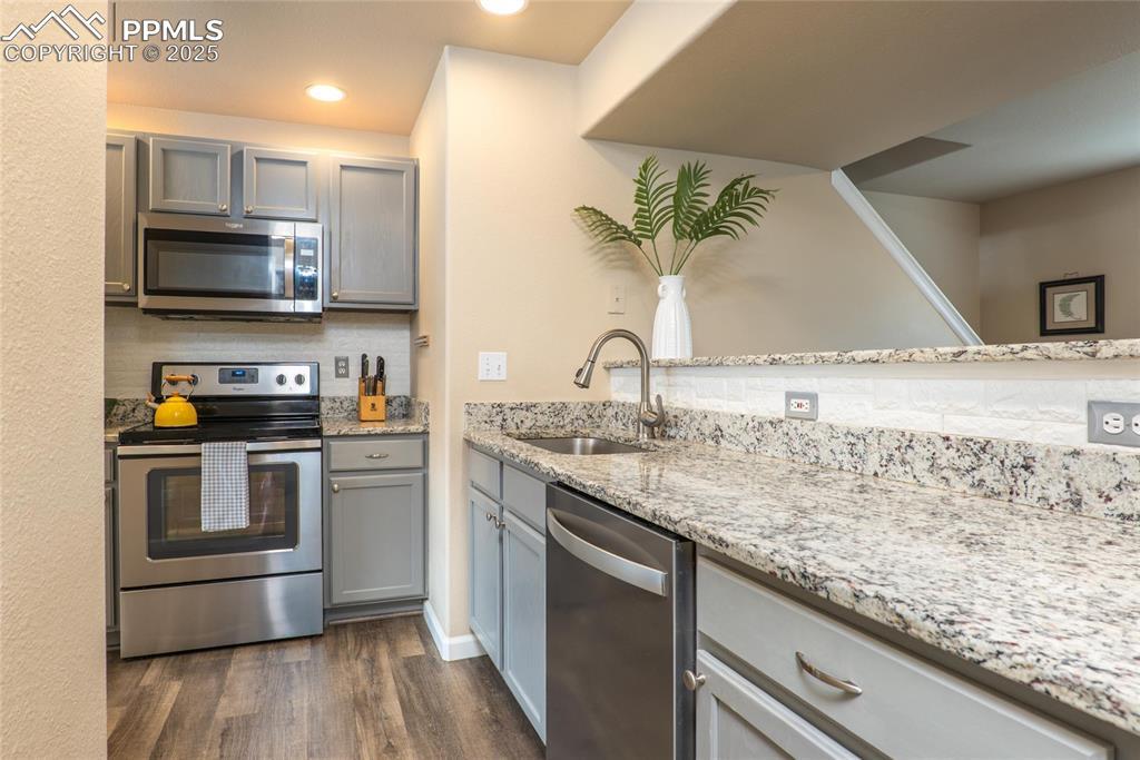 Image 3: Granite counters, Farmhouse Sink, SS Appliances and LVP Flooring.