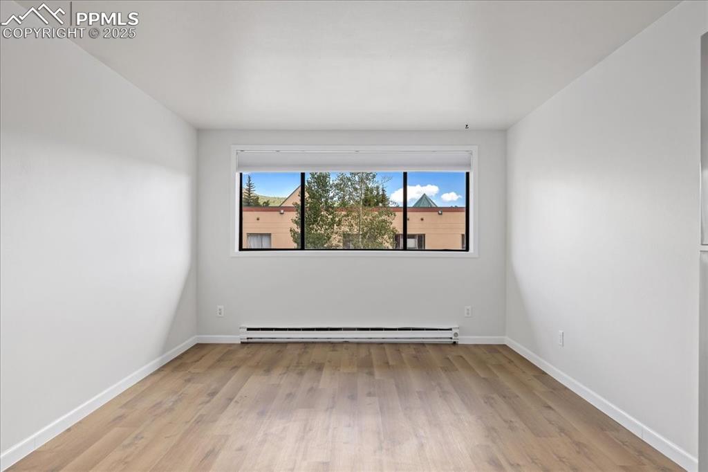 Image 4: Spare room featuring light wood finished floors and a baseboard radiator