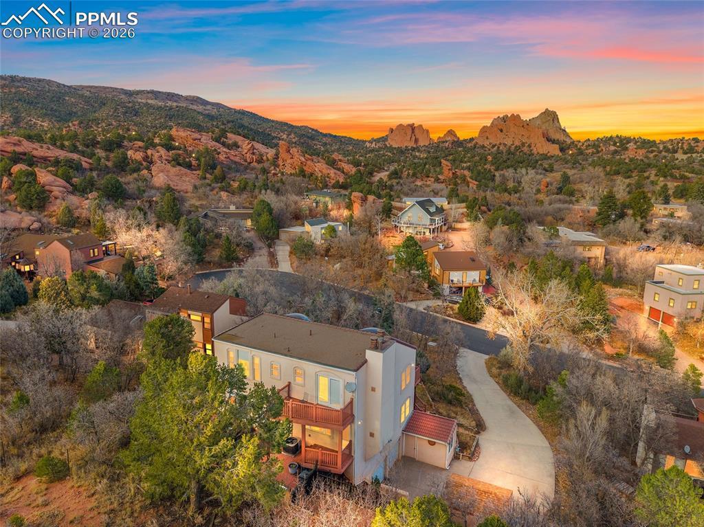 Image 1: Twilight enhanced rear shot of home looking east with a view of Garden of the Gods.