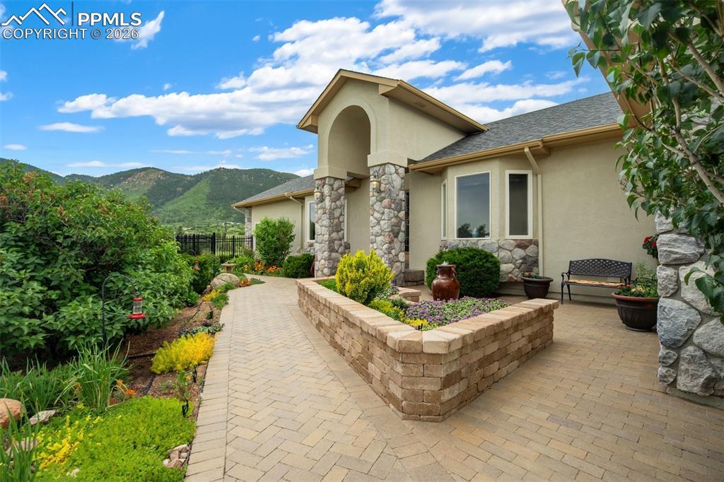 Image 3: The front patio is a gardener's paradise.