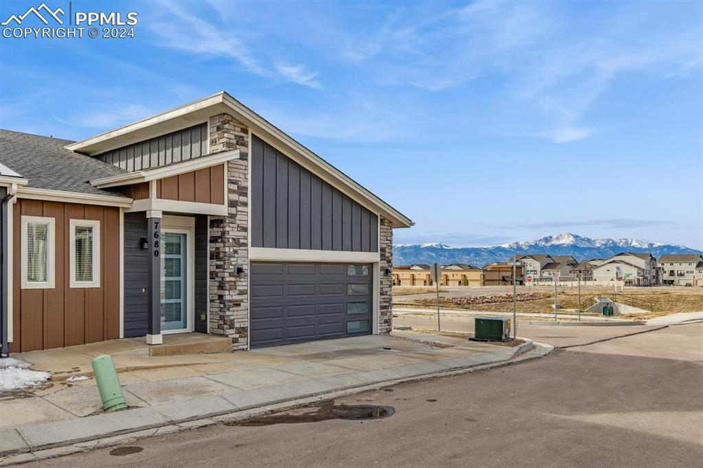 Image 2: View of front of house with a mountain view and a garage