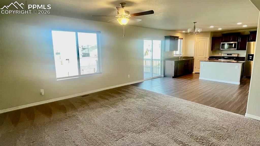 Image 3: Bright open-concept living area with seamless kitchen flow.