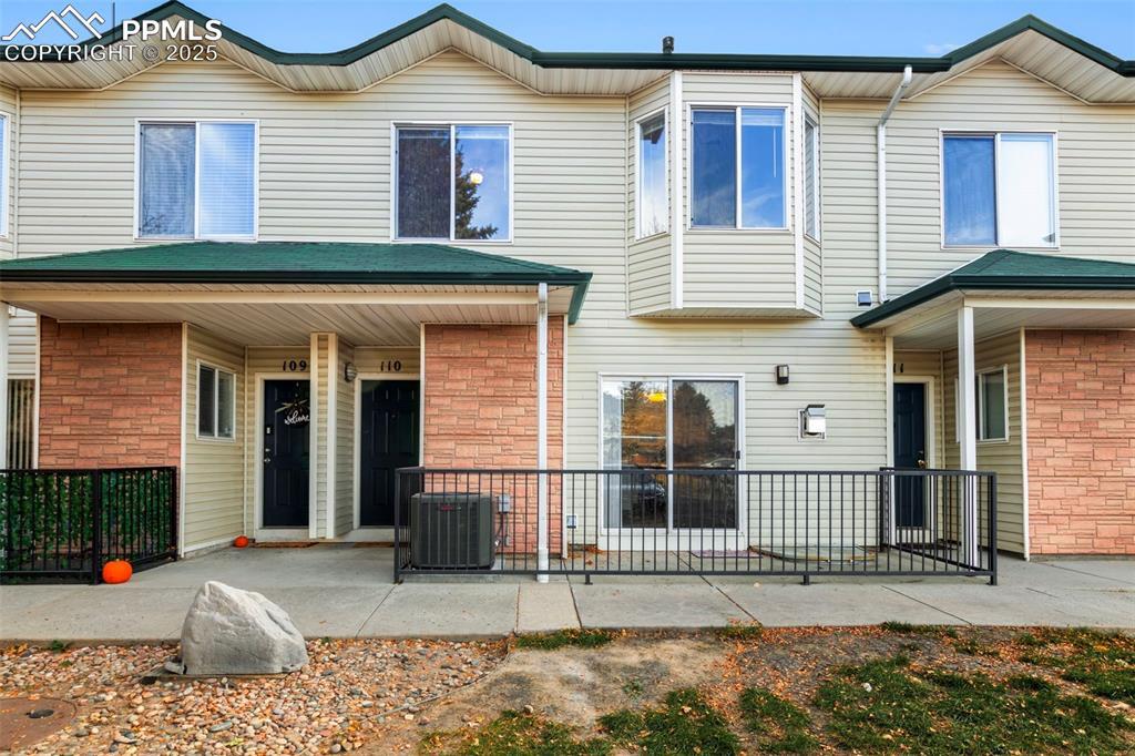Image 1: Rear view of property featuring a porch
