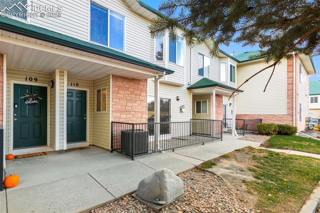 Image 3: Property entrance with a porch and stone siding