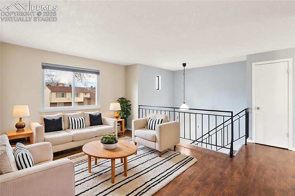 Image 3: Living area featuring wood finished floors, "Virtually Staged"