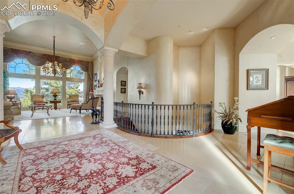 Image 4: Generous Entryway Showcases Custom Ironwork And Travertine Heated Floors.