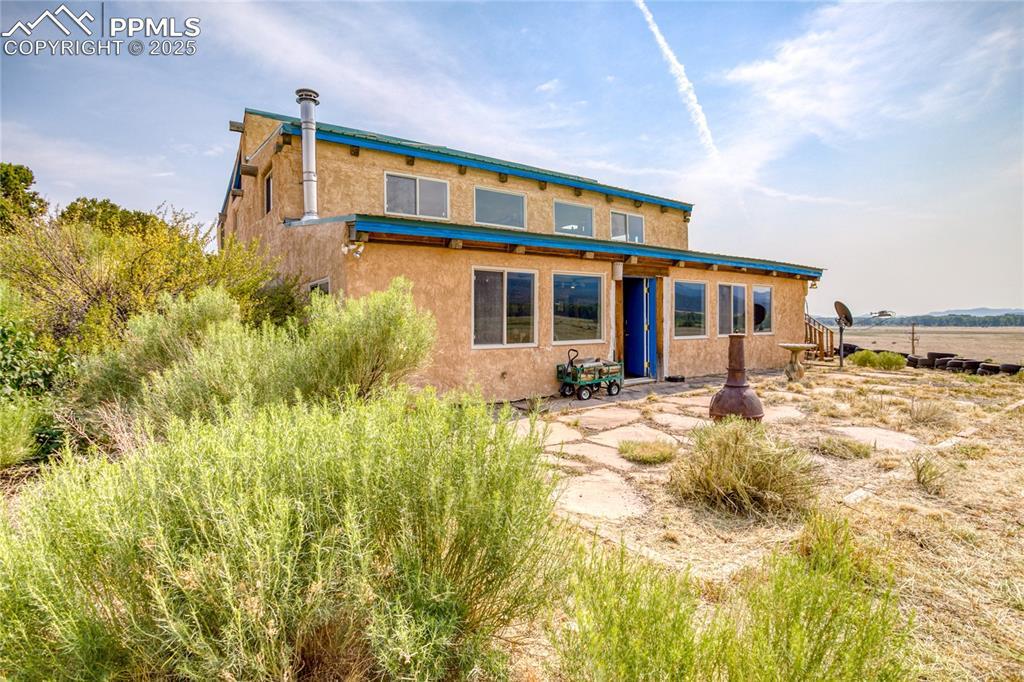 Image 3: Back of house featuring a patio and stucco siding