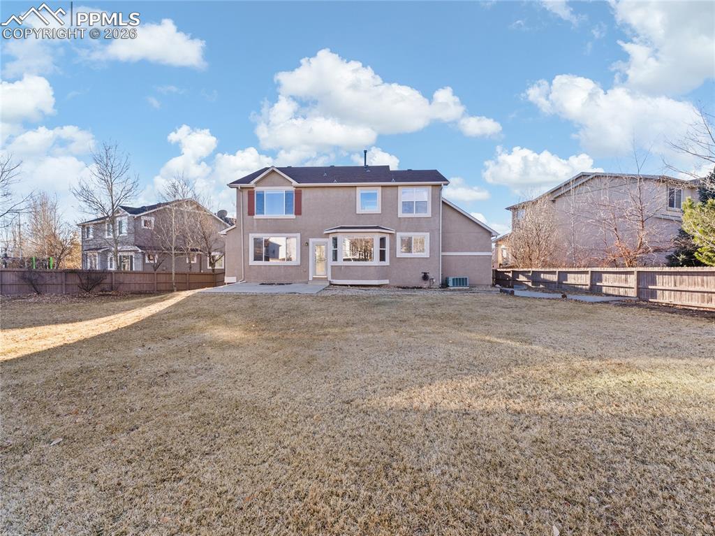 Image 4: Back of property featuring a fenced backyard and a patio area