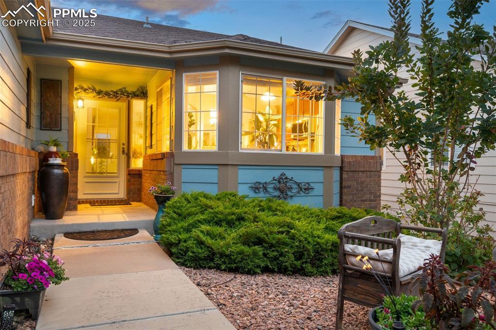 Image 3: Property entrance featuring brick siding and roof with shingles