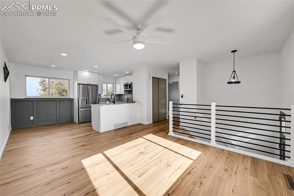 Image 3: Kitchen featuring recessed lighting, light countertops, ceiling fan, white cabinetry, and stainless steel appliances