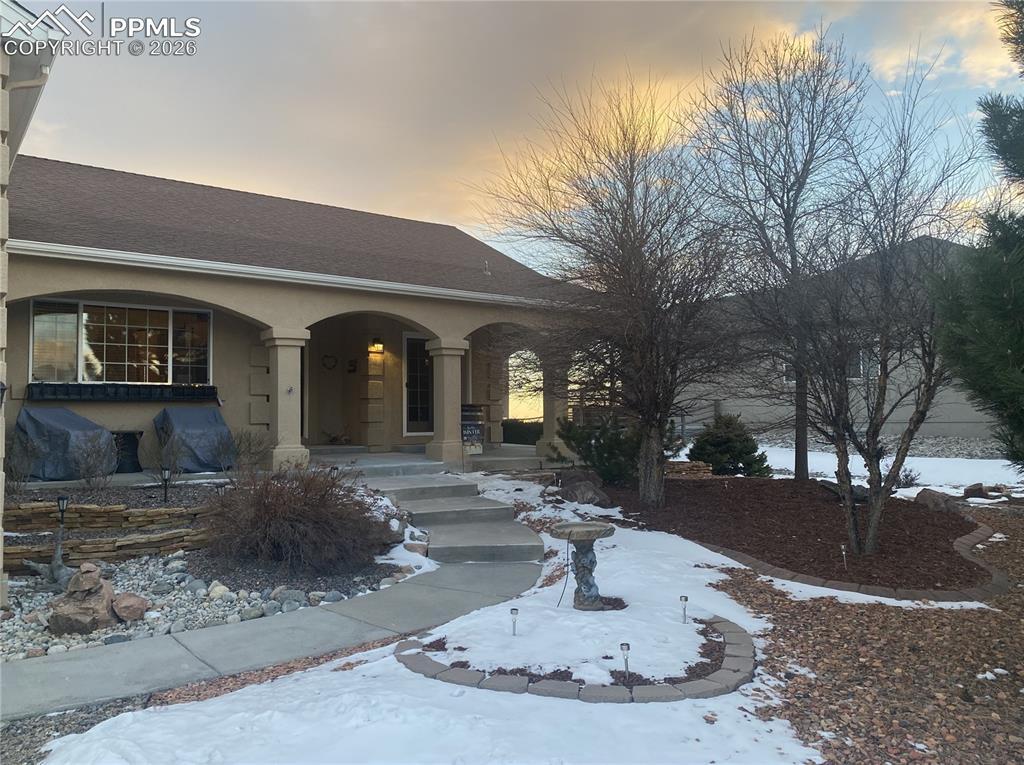 Image 3: A welcoming covered front entry with spacious sitting area creates inviting curb appeal and comfortable outdoor living space great for relaxing or greeting guests.