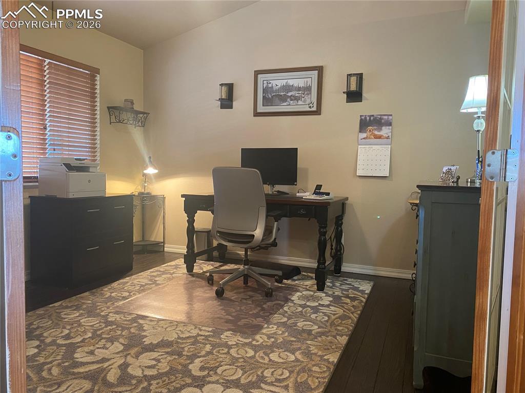 Image 4: This functional home office, thoughtfully converted from a formal dining room, offers flexible living space for remote work, study, or a private workspace.