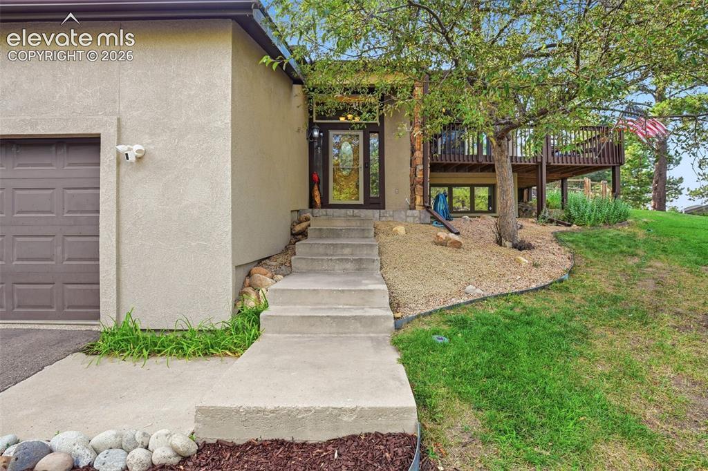 Image 3: As you enter this home, you walk onto a landing with stairs to the basement and stairs to the living room/kitchen.