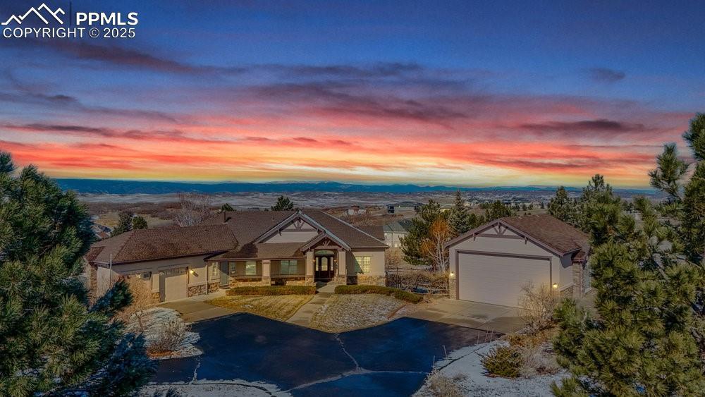 Image 1: View of front of property featuring a garage, concrete driveway, and a mountain view